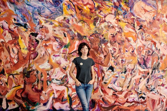 Cecily Brown with her painting “Triumph of the Vanities II,” in the Dress Circle of the